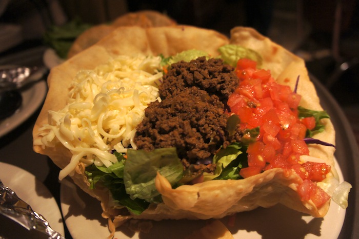 Taco Salad $8.99 - Homemade tortilla bowl with fresh, mixed salad  greens, tomatoes, cheese, guacamole & your choice  of fajita chicken, fajita beef or seasoned ground sirloin