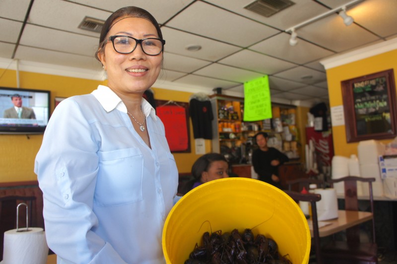 Mrs. Ha Nguyen shows off her fresh live crawfish delivered straight from Louisiana 
