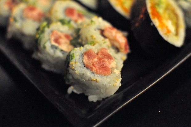 Dynamite roll - tuna with wasabi mayo and cucumber, sprinkled with  sesame seeds  and sliced green onion on the outside  