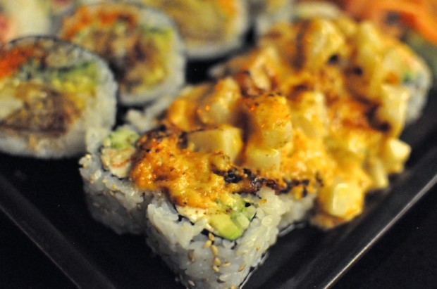 Volcano roll - chopped scallop, spicy mayo on top of California roll with cream cheese  