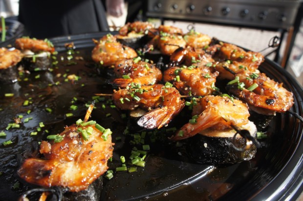 Grilled sugarcane skewered Kalbi shrimp and pineapple atop Avo Kyu roll - The Meat House in Winter Park