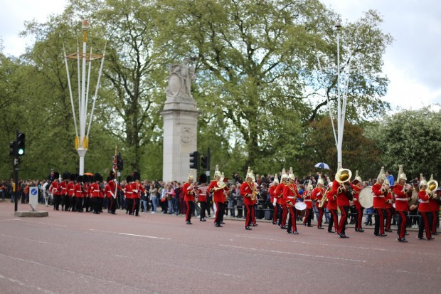 A troop marches down the way with band in tow for The Changing of the Guard at Buckingham Palace