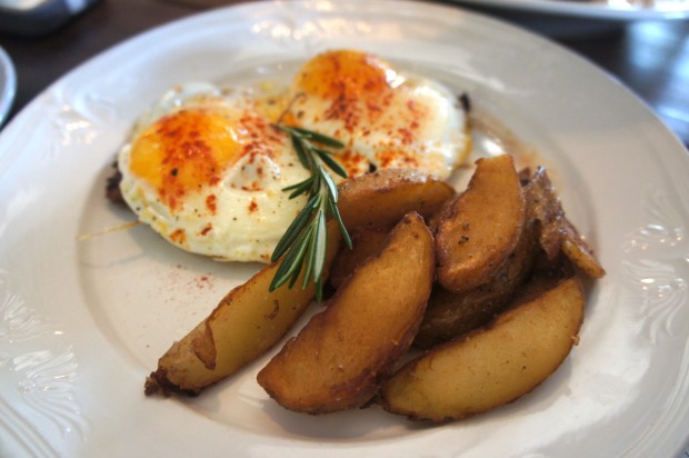 Benedict Lomo - pan de gallego, tomato relish, lomo ham, poached local egg, saffron hollandaise, and charred vegetables - $12