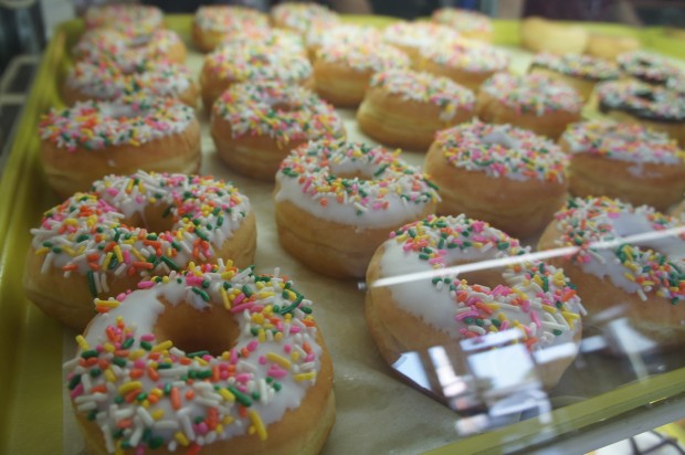 Rainbow sprinkled vanilla frosting donuts