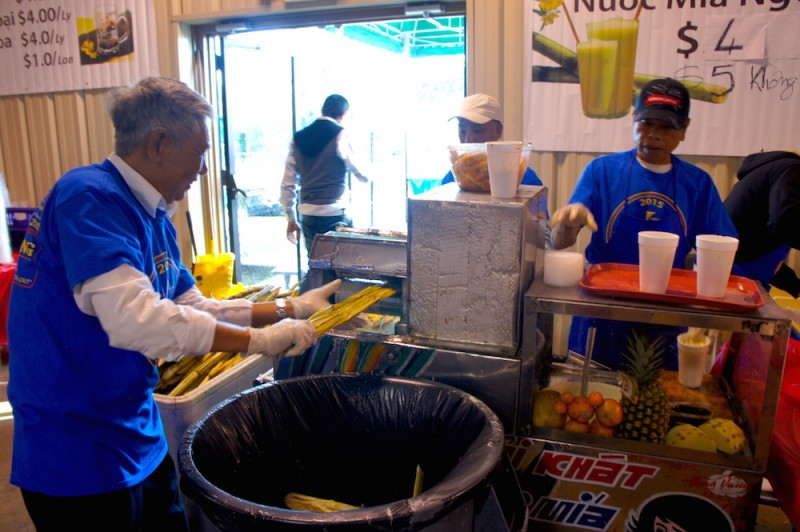 Grinding sugarcane to make sugarcane juice